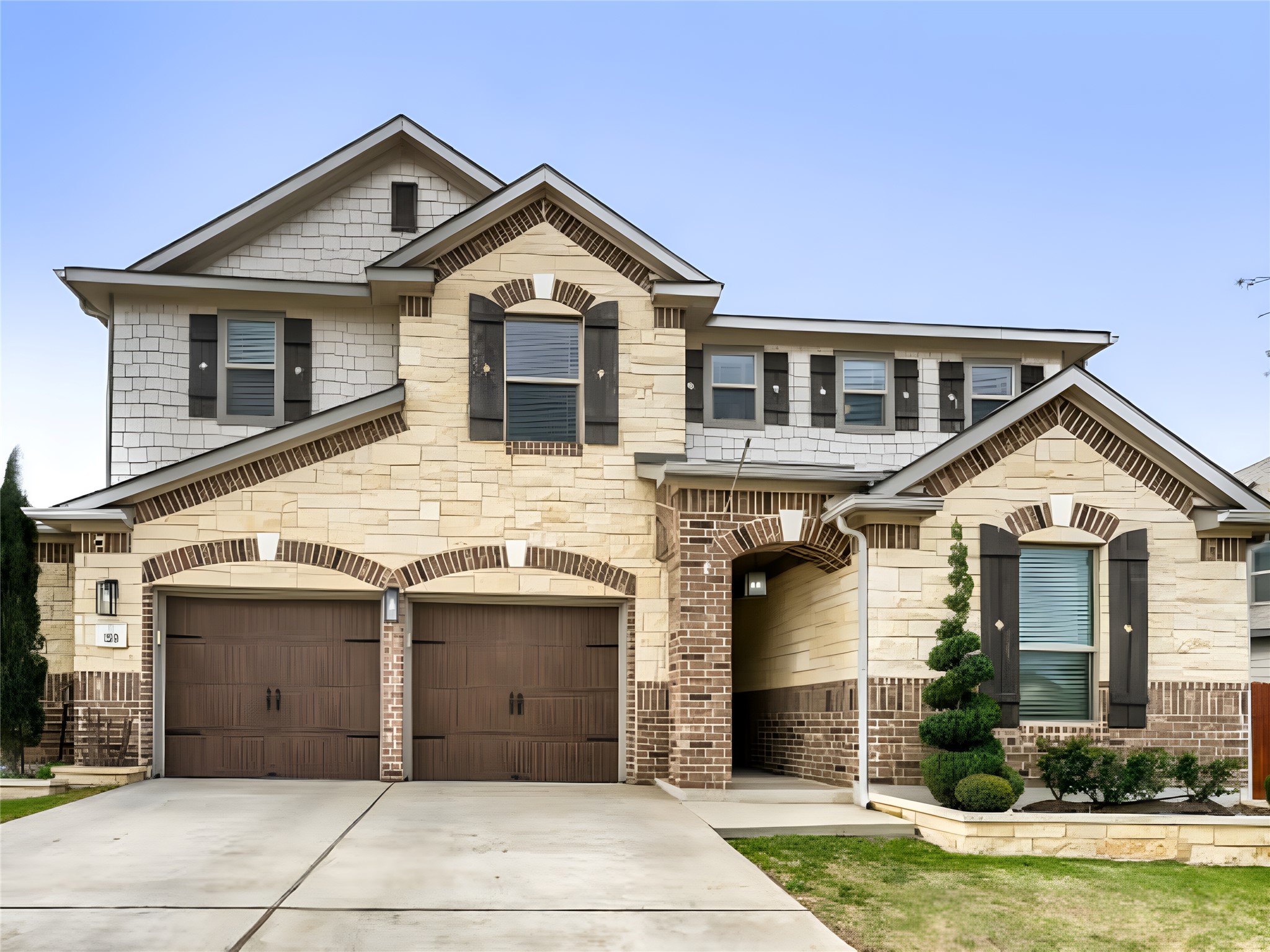 a front view of a house with garden