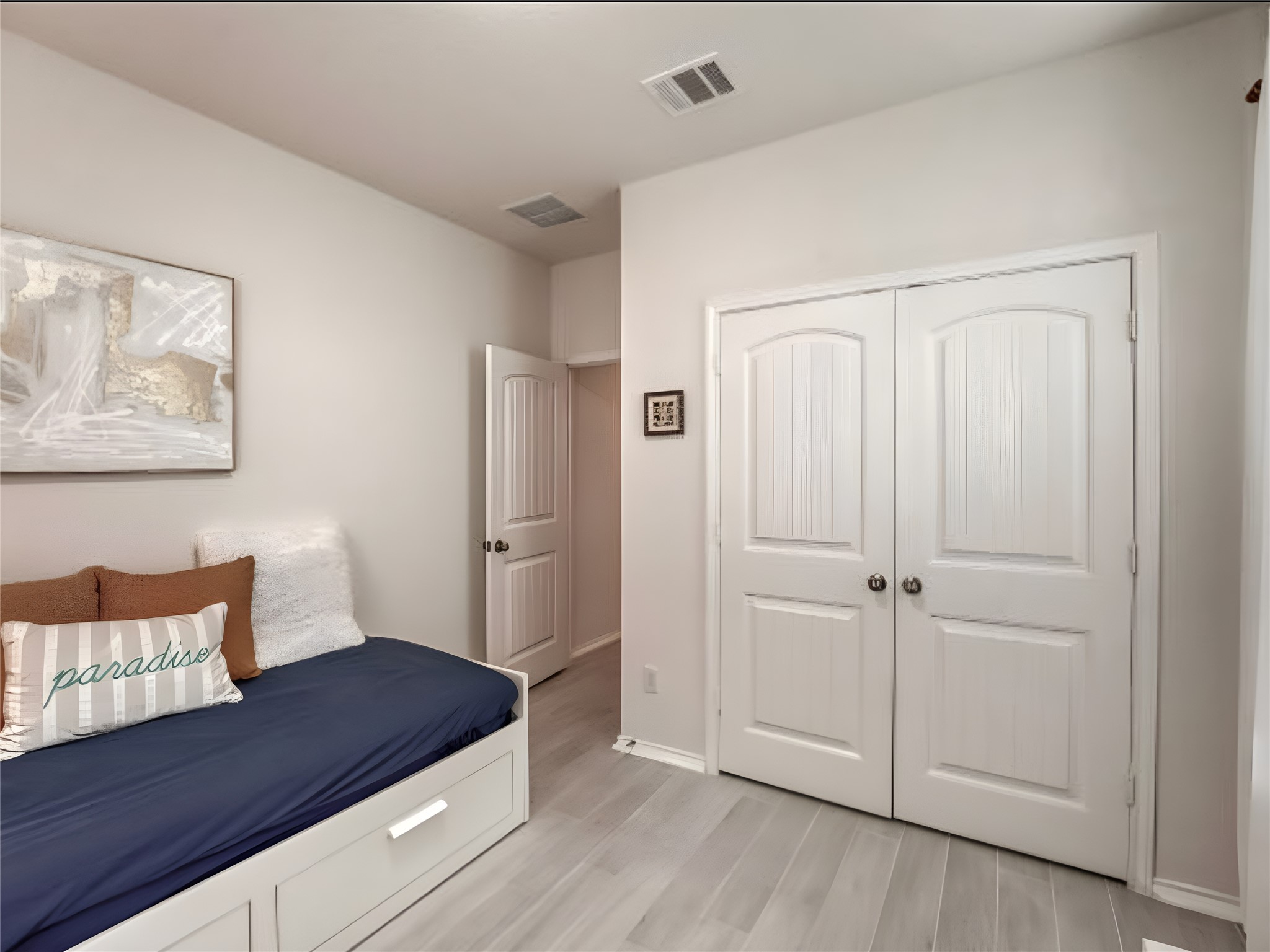 159 Kennicott Drive Kyle, TX 78640 - Photo 15 of 27 a bedroom with a bed and a painting on the wall