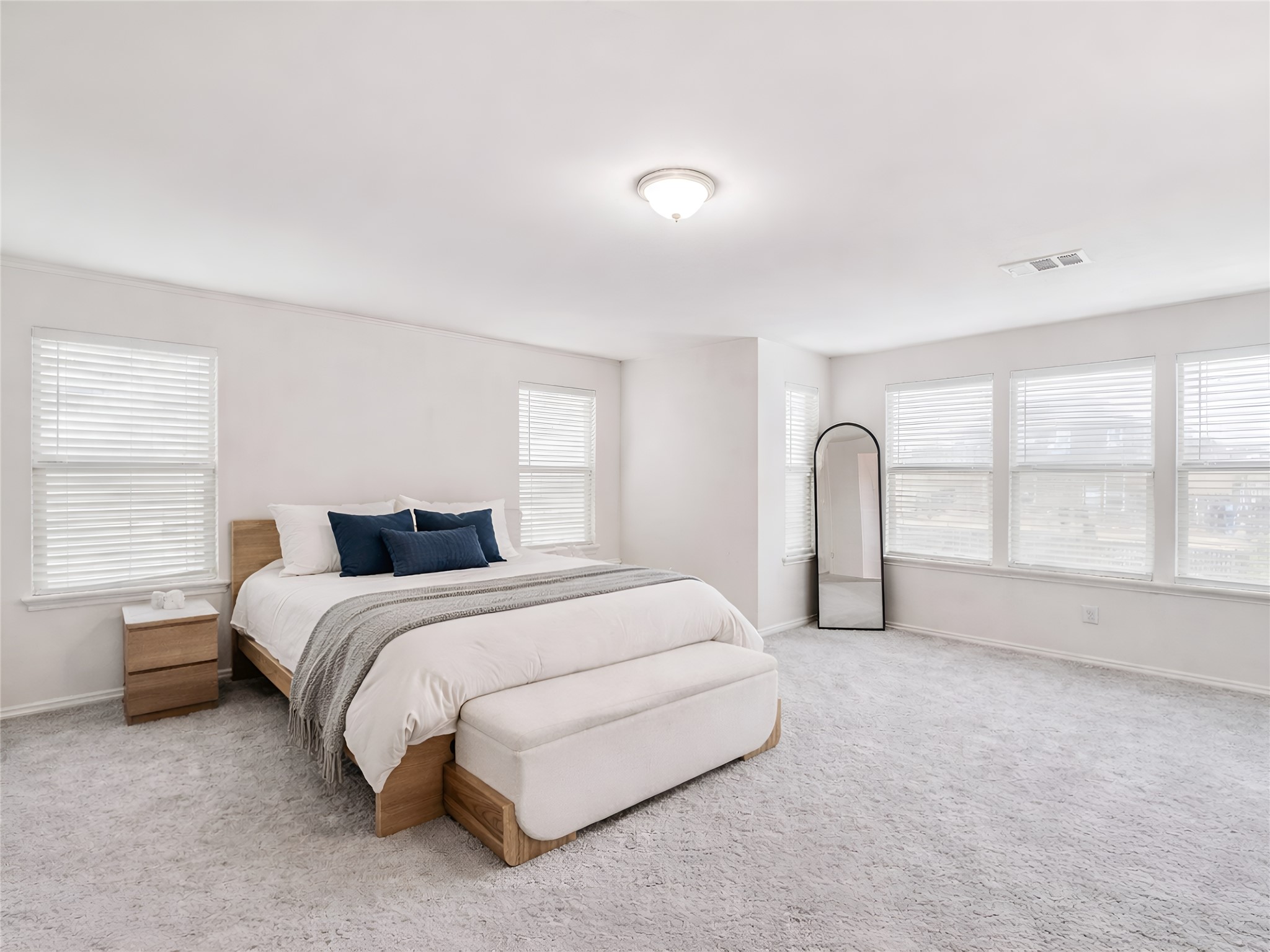 159 Kennicott Drive Kyle, TX 78640 - Photo 18 of 27 a spacious bedroom with a bed and a large window