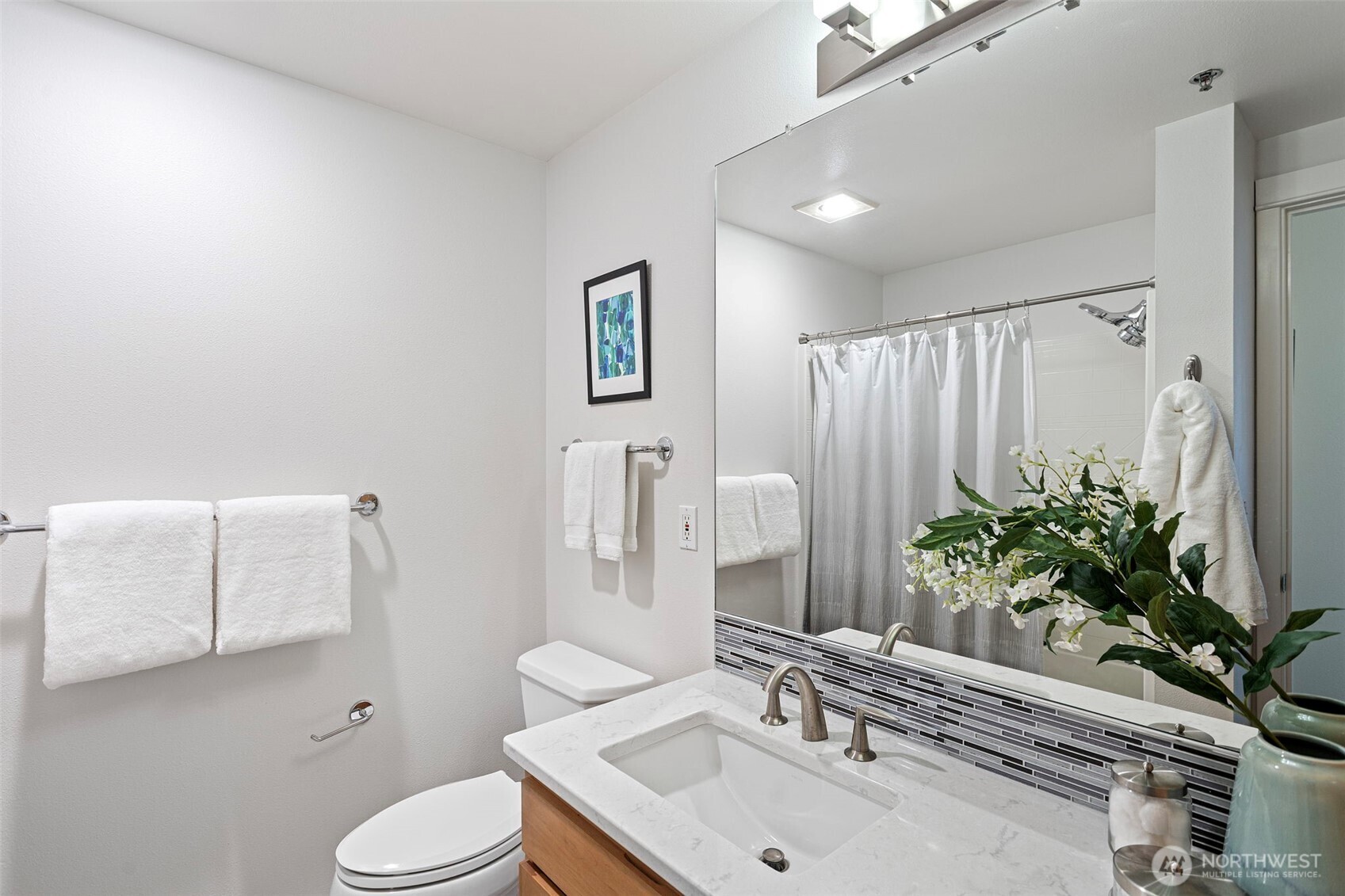 2801 1st Avenue, Unit 612 Seattle, WA 98121 - Photo 16 of 25 a bathroom with a sink a toilet and mirror