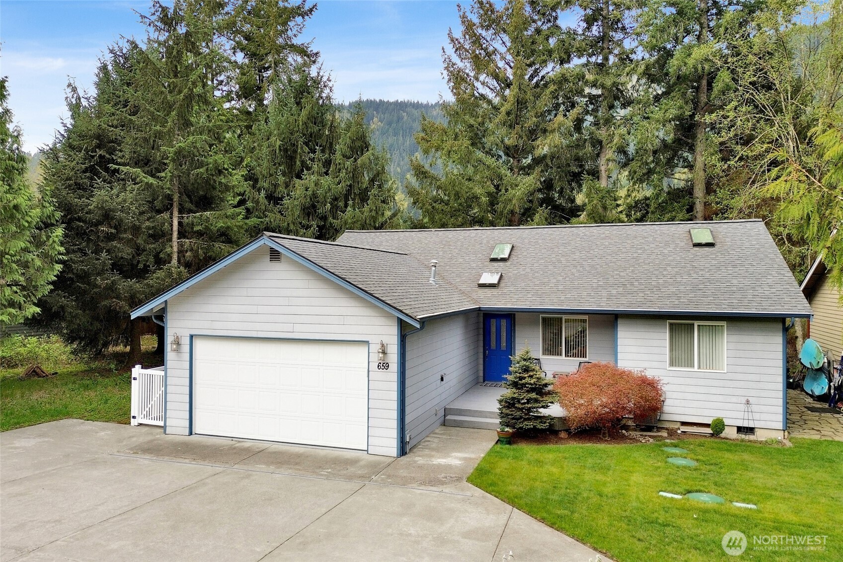 659 Cain Lake Road Sedro-Woolley, WA 98284 - Photo 2 of 40 a view of a house with a yard plants and large tree