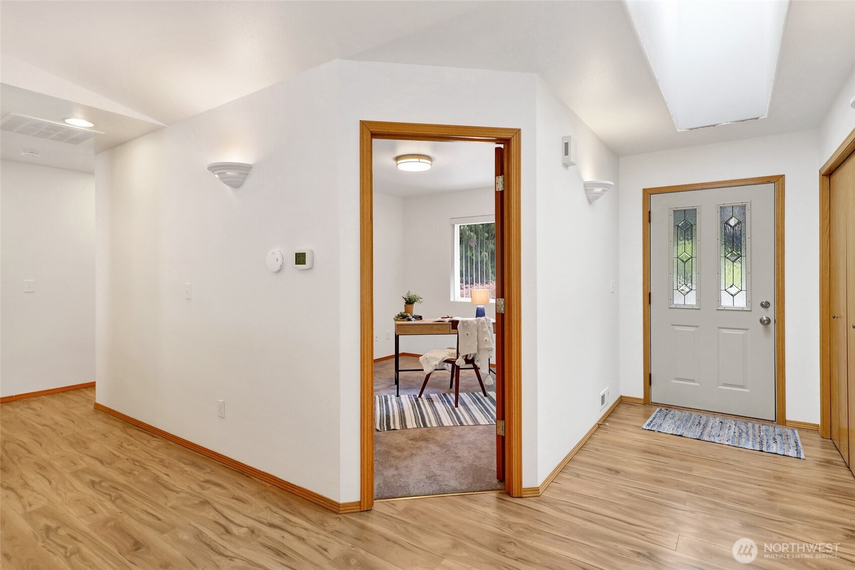 659 Cain Lake Road Sedro-Woolley, WA 98284 - Photo 10 of 40 a view of a hallway and wooden floor a livingroom with wooden floor