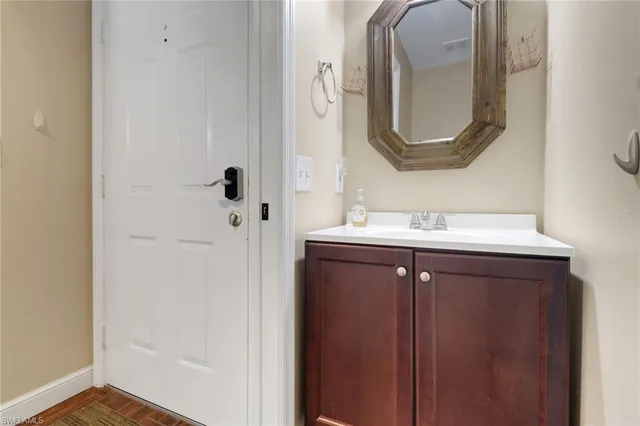 a bathroom with a sink vanity and a mirror