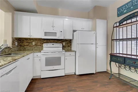 a white refrigerator freezer sitting inside of a kitchen