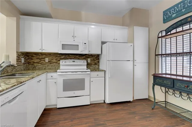 a white refrigerator freezer sitting inside of a kitchen