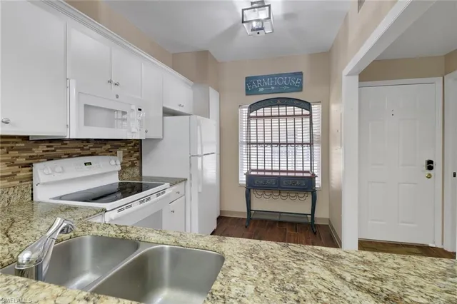 a kitchen with a refrigerator and a sink