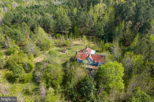 a backyard of a house with a yard and outdoor seating
