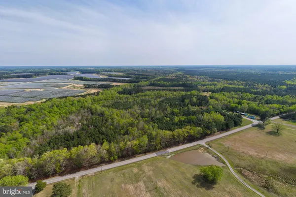 an aerial view of a houses with a yard