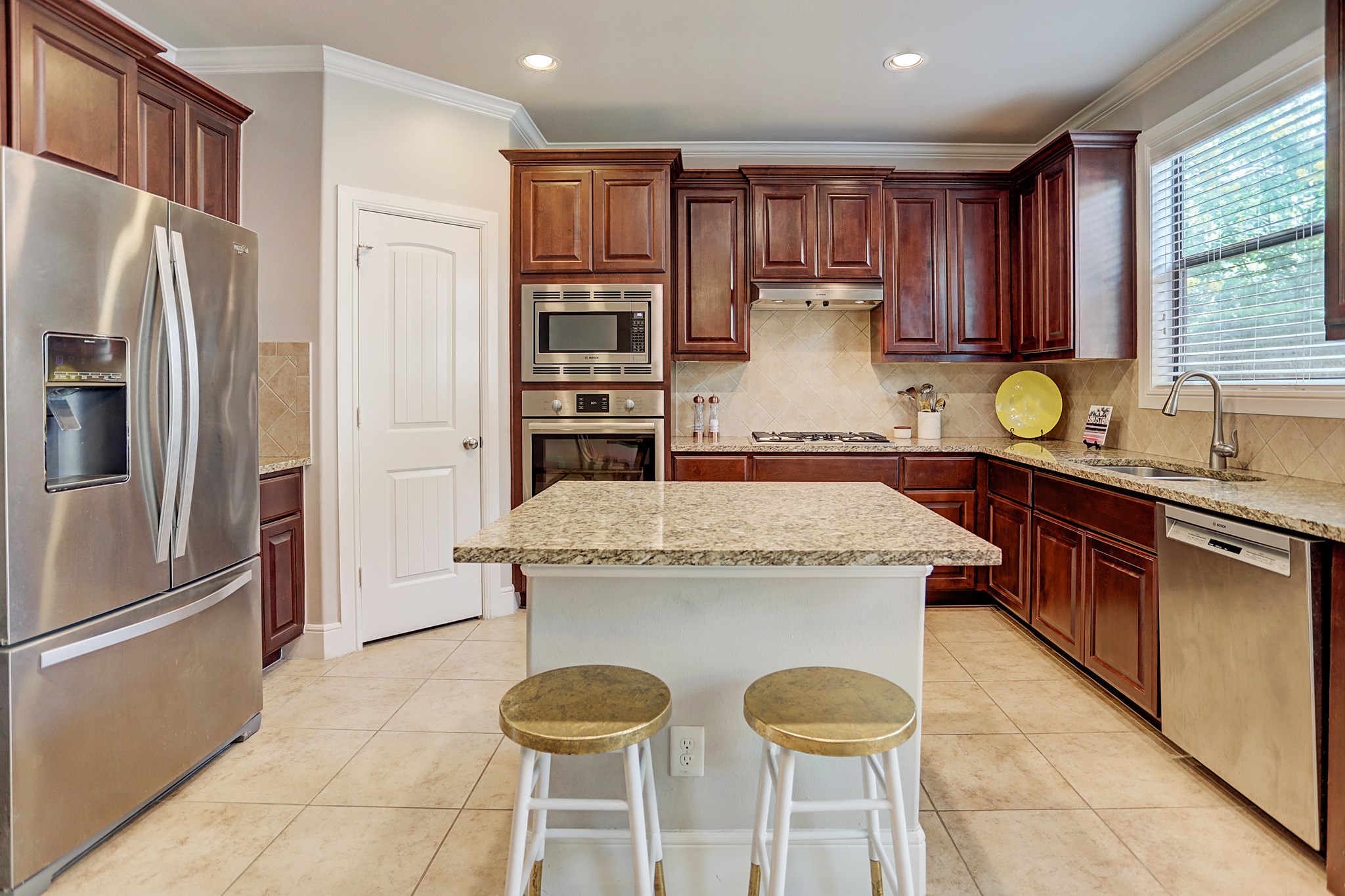 213 West 26th Street Houston, TX 77008 - Photo 11 of 33 a kitchen with stainless steel appliances granite countertop a sink a stove and a refrigerator