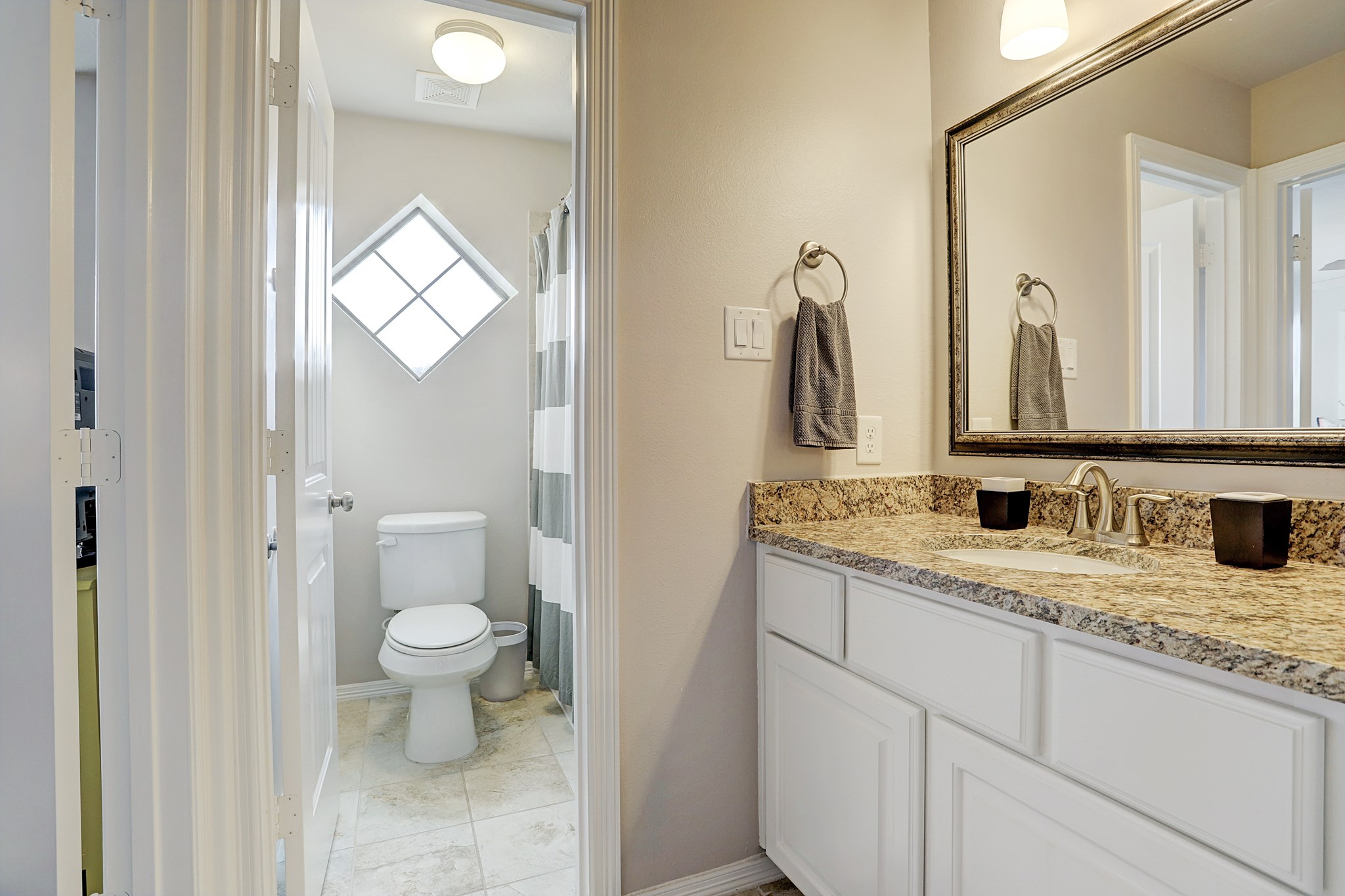 213 West 26th Street Houston, TX 77008 - Photo 22 of 33 a bathroom with a granite countertop toilet sink and mirror