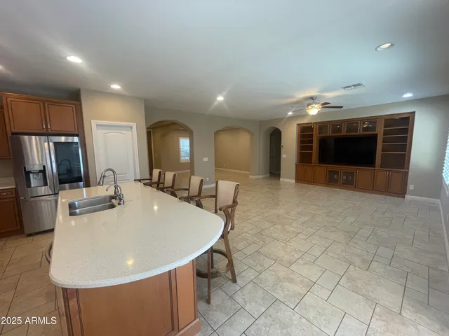 a large kitchen with a table and chairs