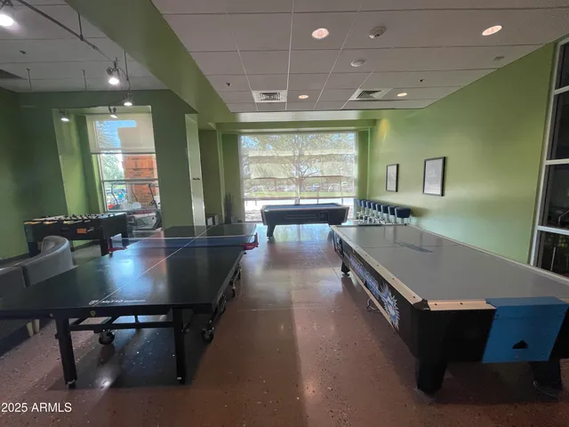 a lobby with furniture and floor to ceiling window