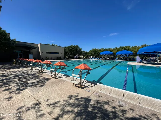 a living room with lots of furniture and a wooden floor