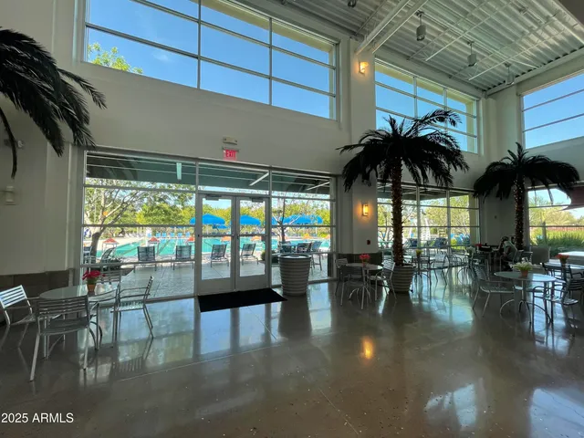 a view of a house with swimming pool and sitting area