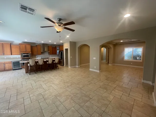 a view of an empty room with a fireplace and a window