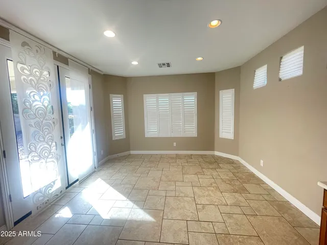 a view of a livingroom with a ceiling fan and window
