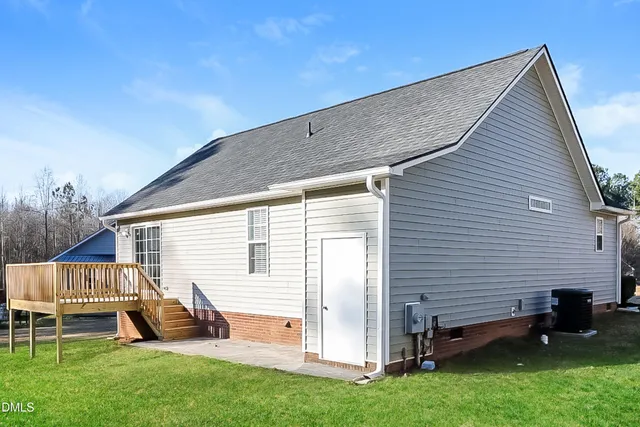 a view of backyard with a chair and a garden