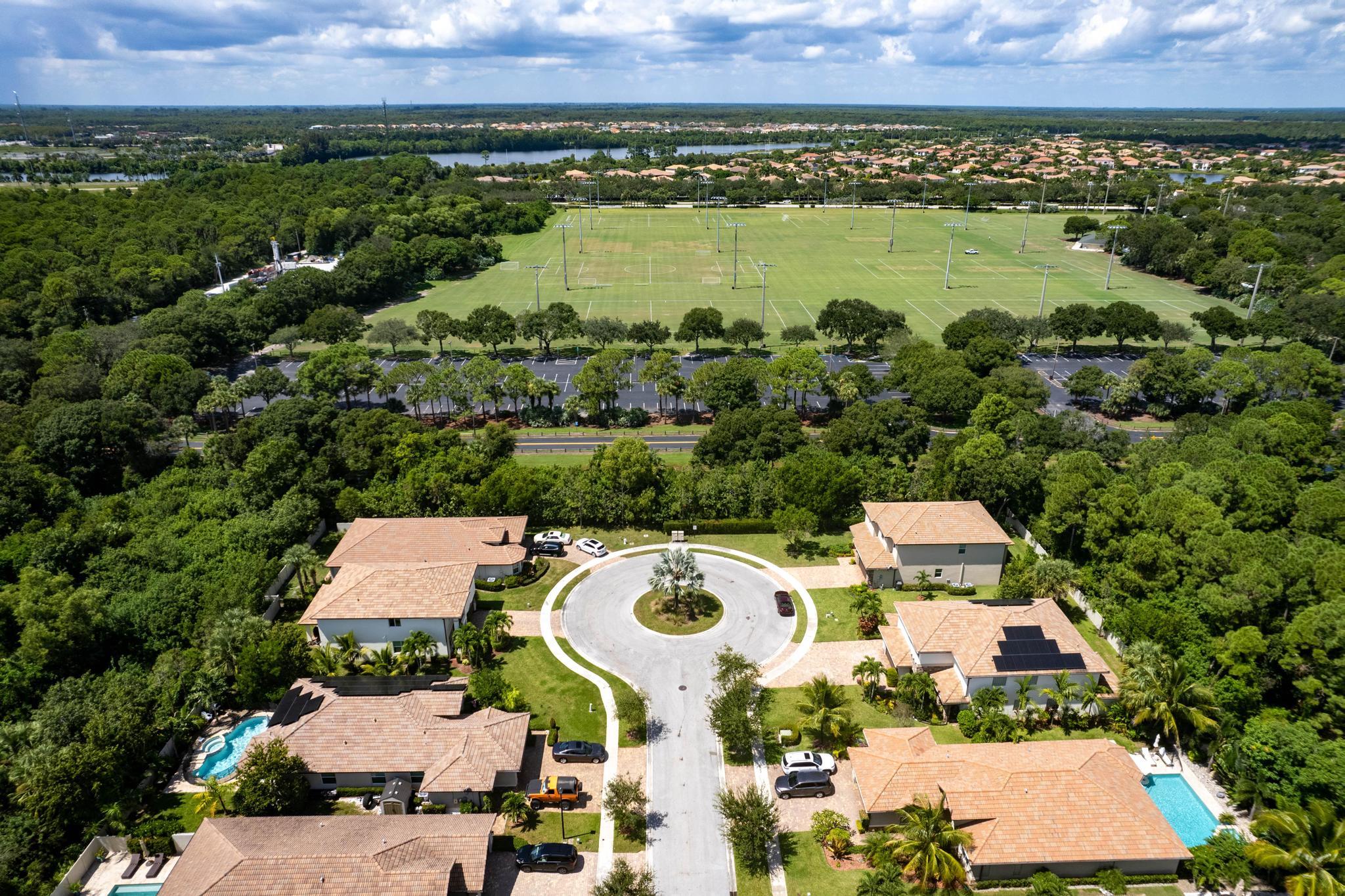 an aerial view of a house with a garden and lake view