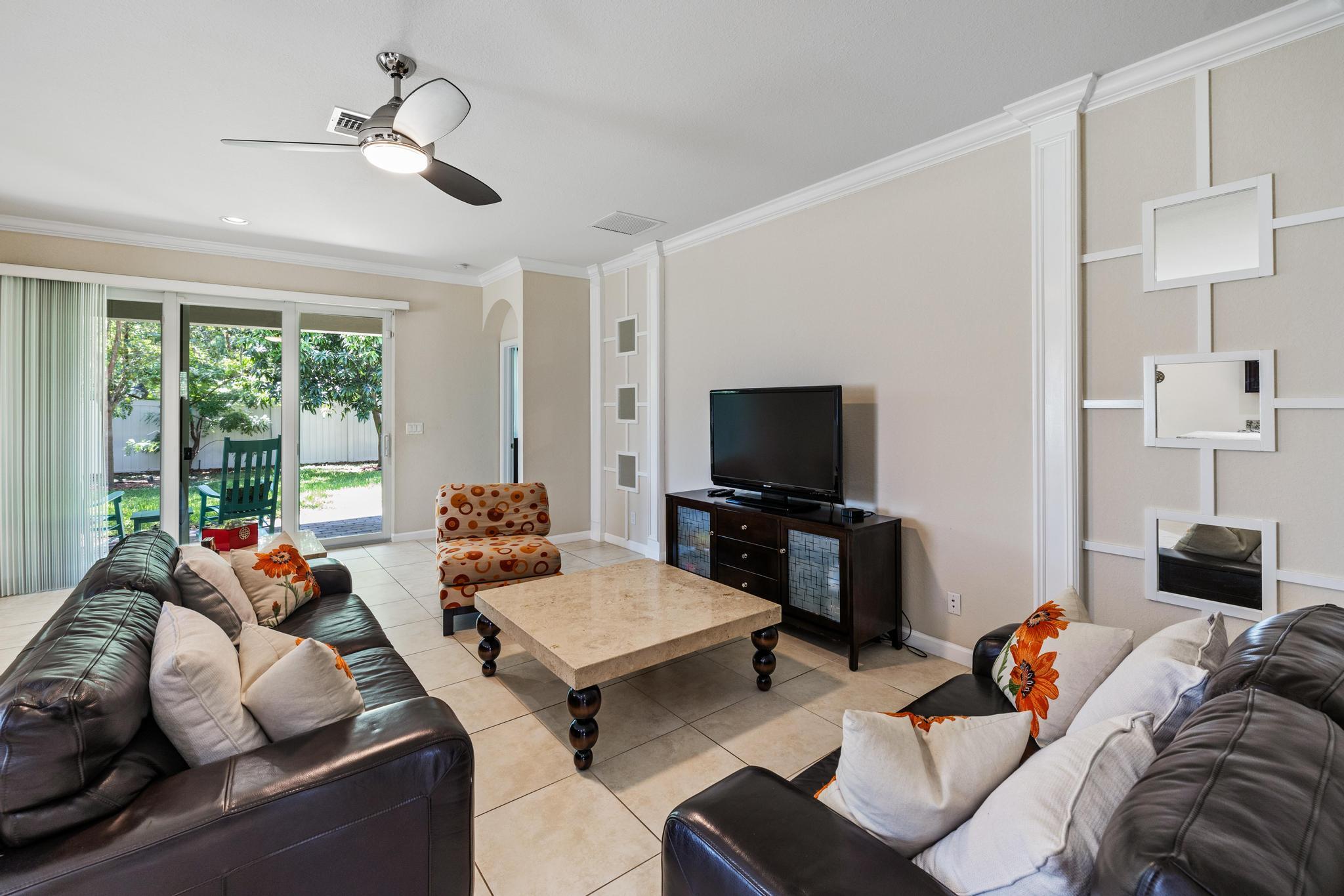 7034 Limestone Cay Road Jupiter, FL 33458 - Photo 12 of 43 a living room with furniture and a flat screen tv