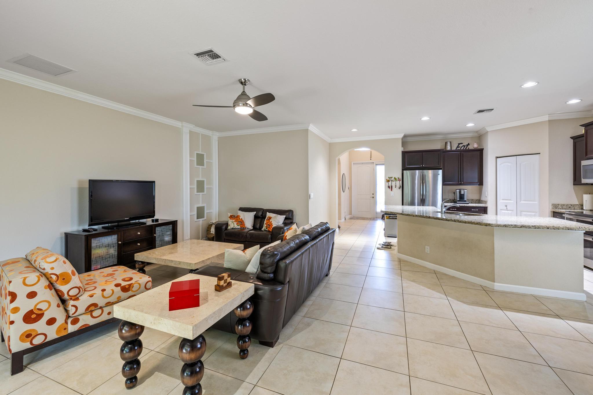 7034 Limestone Cay Road Jupiter, FL 33458 - Photo 14 of 43 a living room with furniture and a flat screen tv