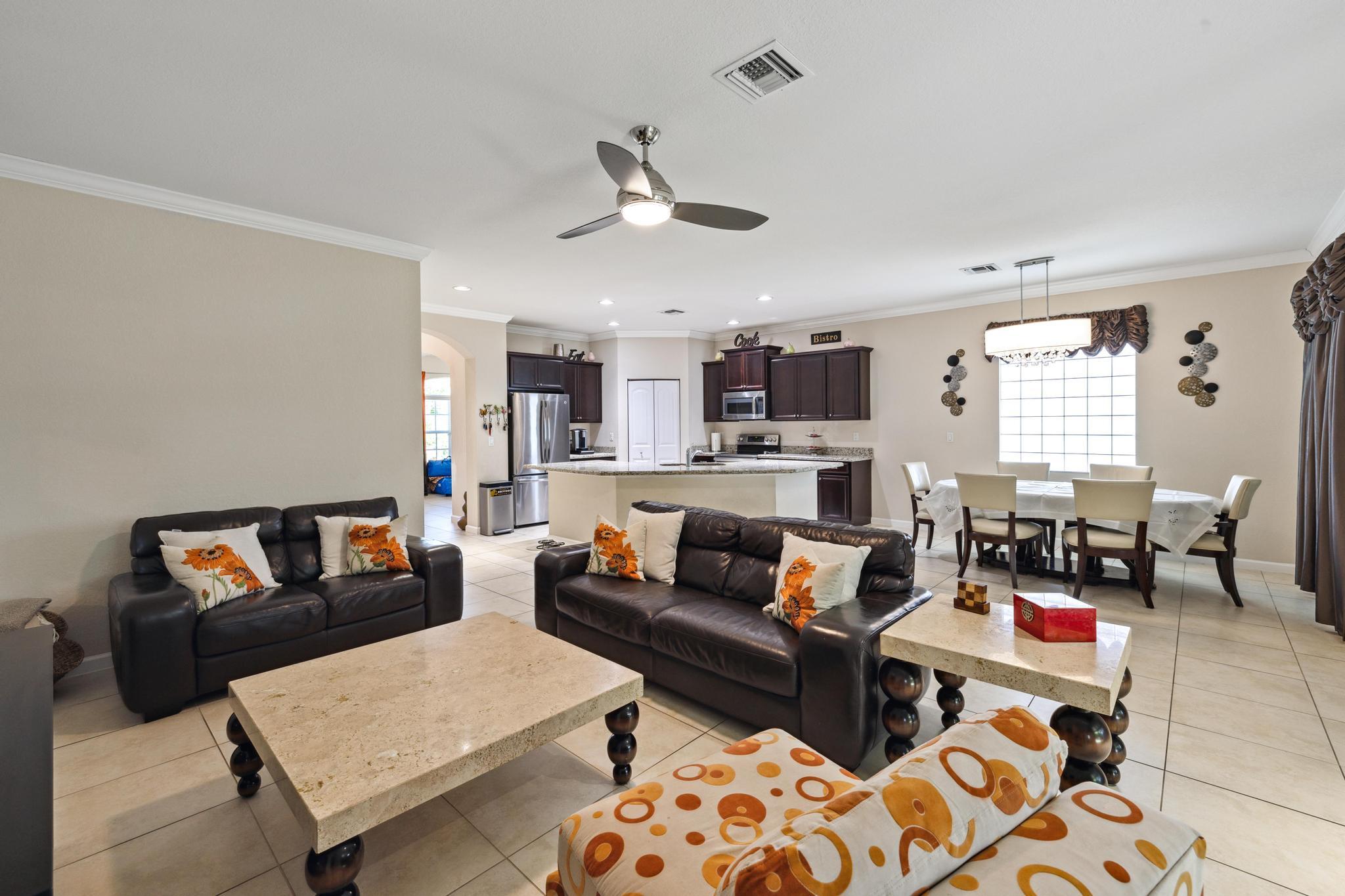 7034 Limestone Cay Road Jupiter, FL 33458 - Photo 15 of 43 a living room with furniture kitchen view and a window