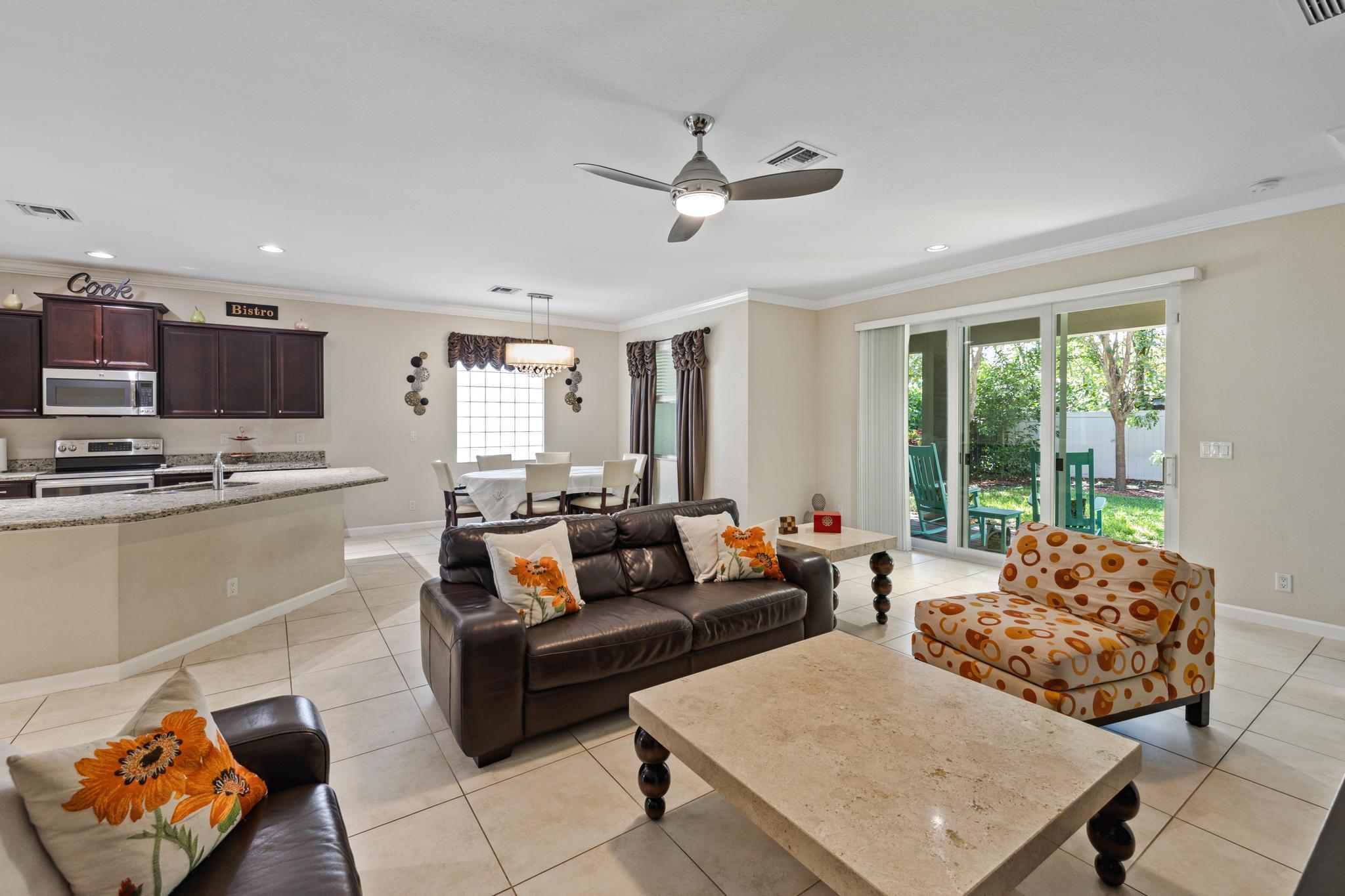 7034 Limestone Cay Road Jupiter, FL 33458 - Photo 16 of 43 a living room with furniture and a large window