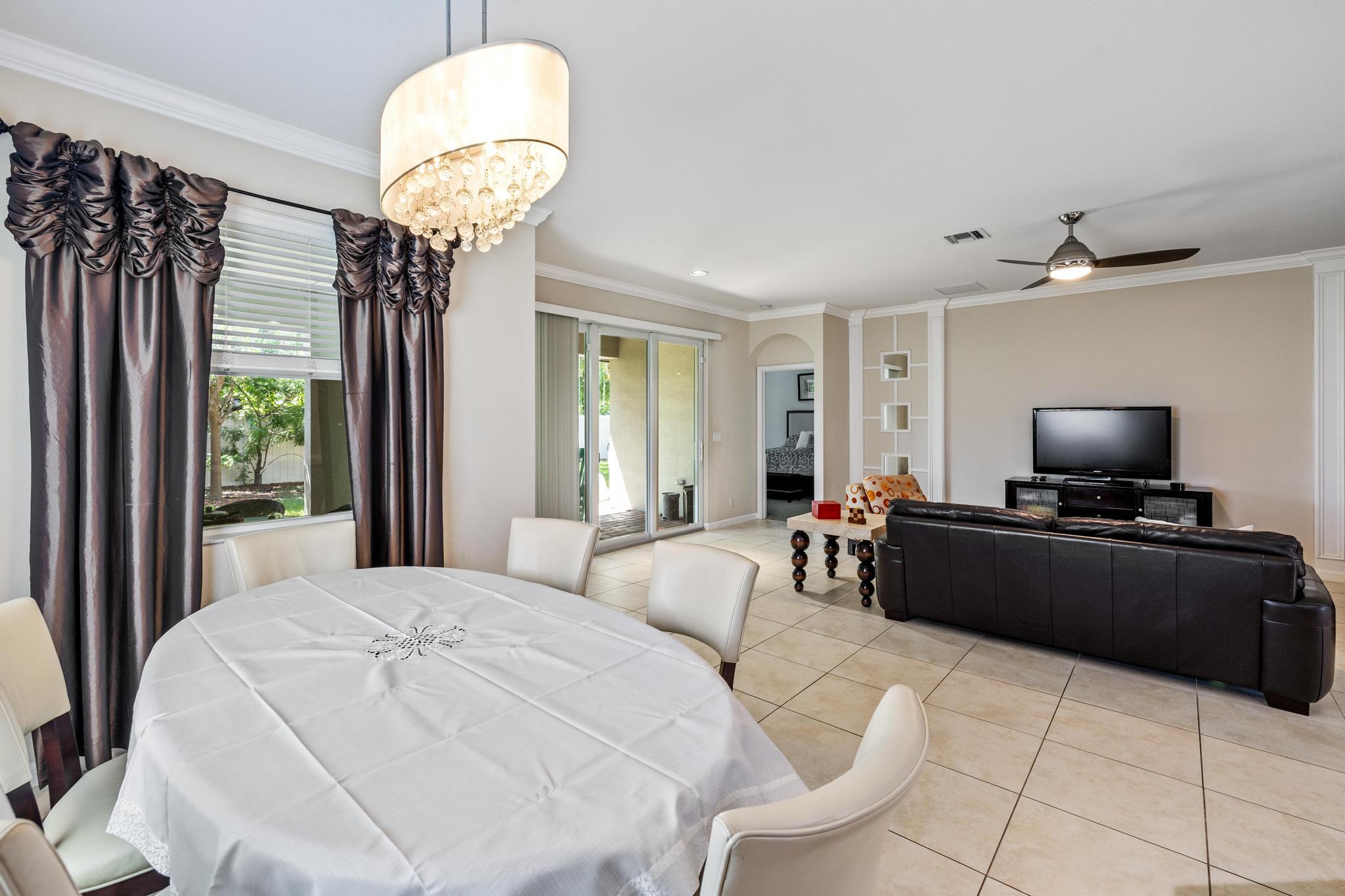 7034 Limestone Cay Road Jupiter, FL 33458 - Photo 18 of 43 a living room with furniture and a flat screen tv