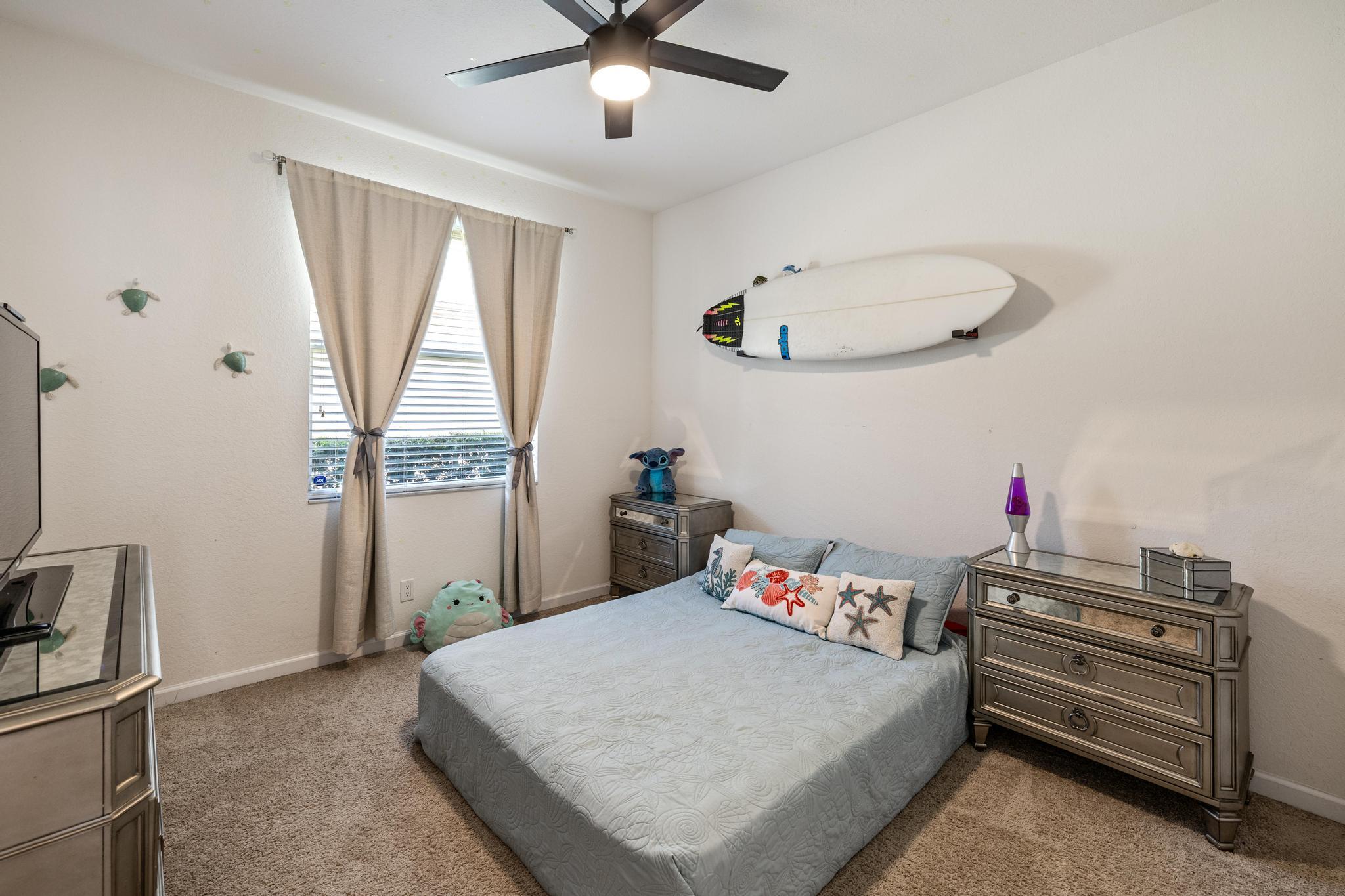 7034 Limestone Cay Road Jupiter, FL 33458 - Photo 19 of 43 a bedroom with a bed and a chandelier