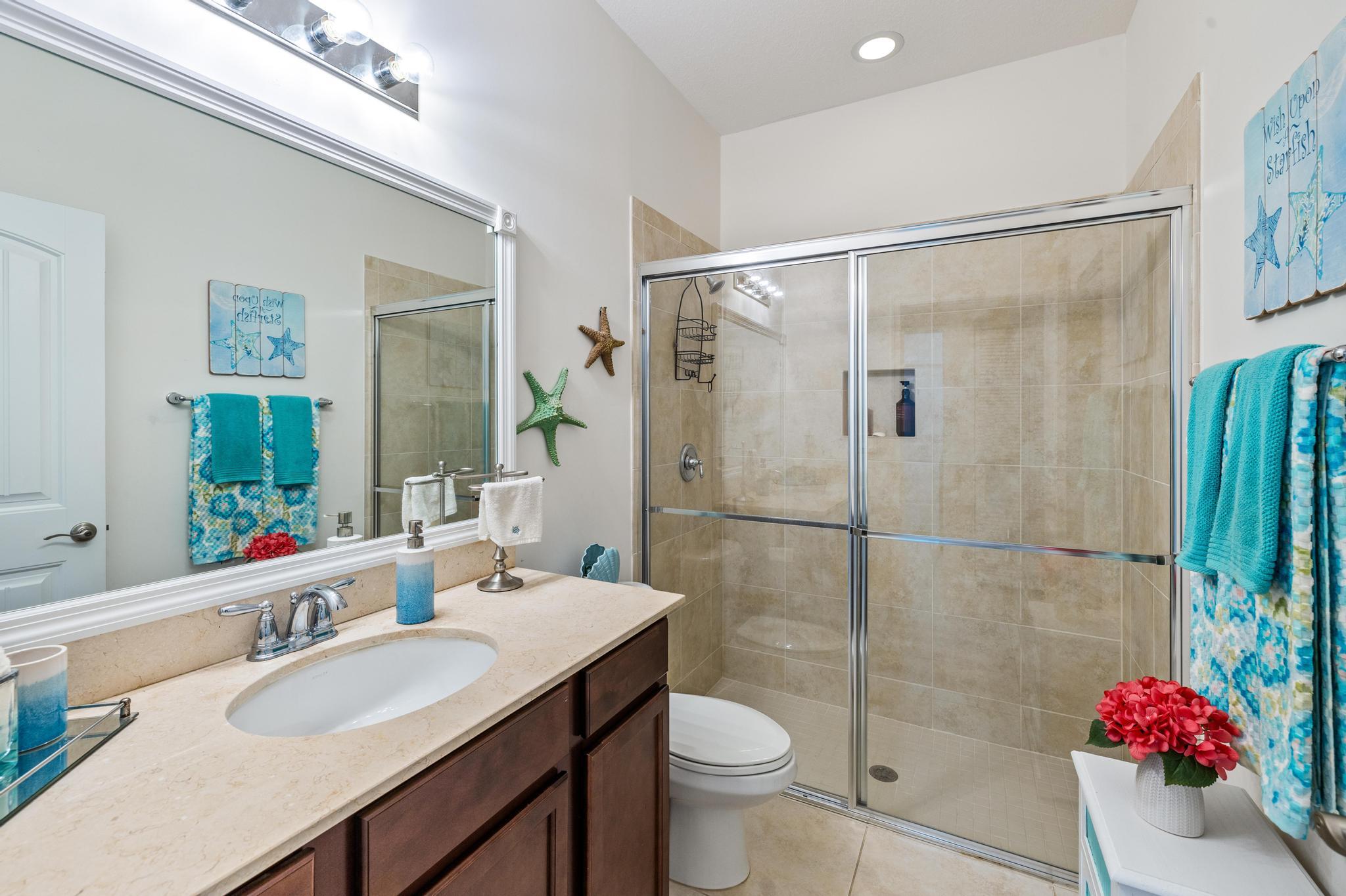 7034 Limestone Cay Road Jupiter, FL 33458 - Photo 21 of 43 a bathroom with a granite countertop shower sink vanity mirror and toilet