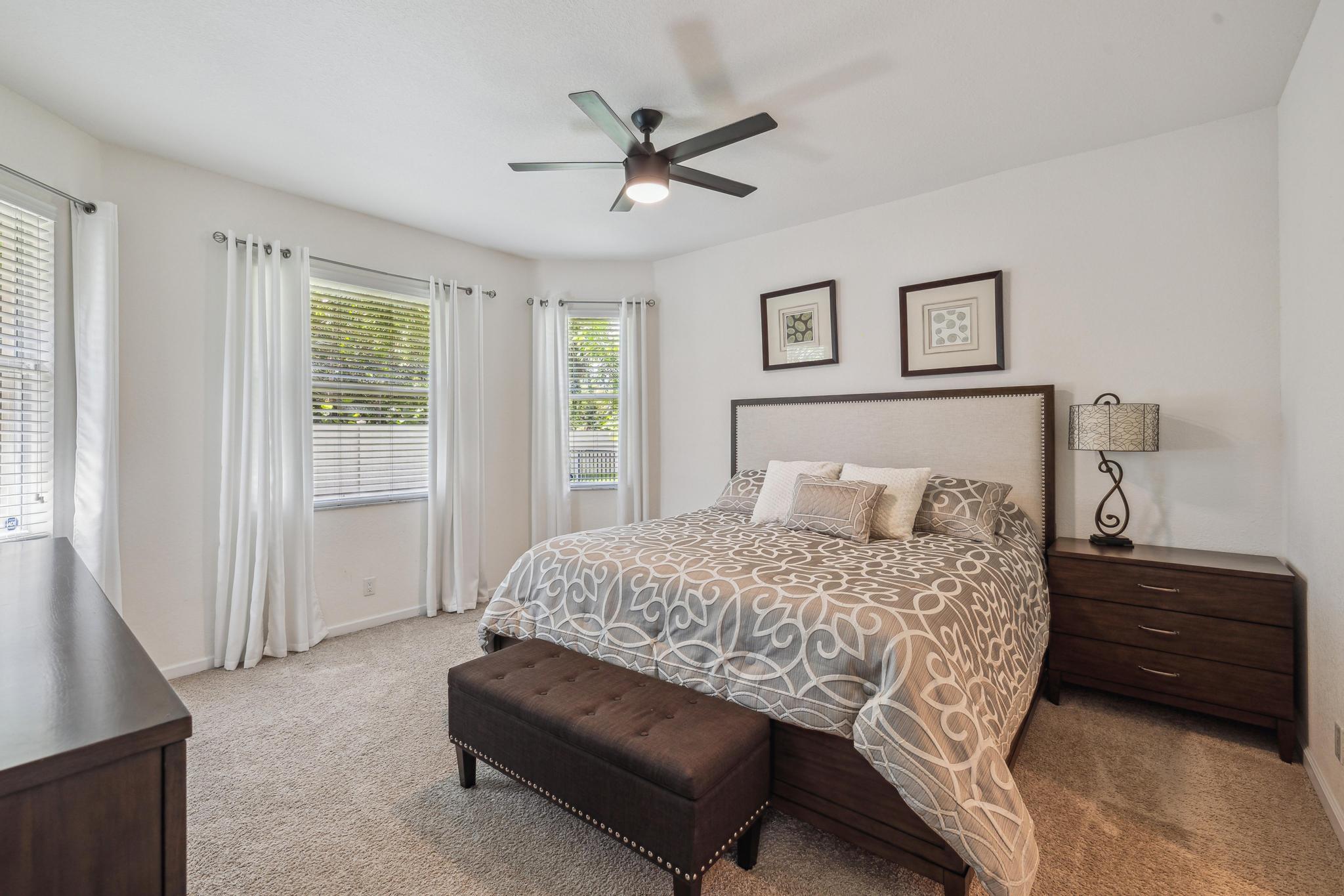 7034 Limestone Cay Road Jupiter, FL 33458 - Photo 24 of 43 a bedroom with a bed and a ceiling fan