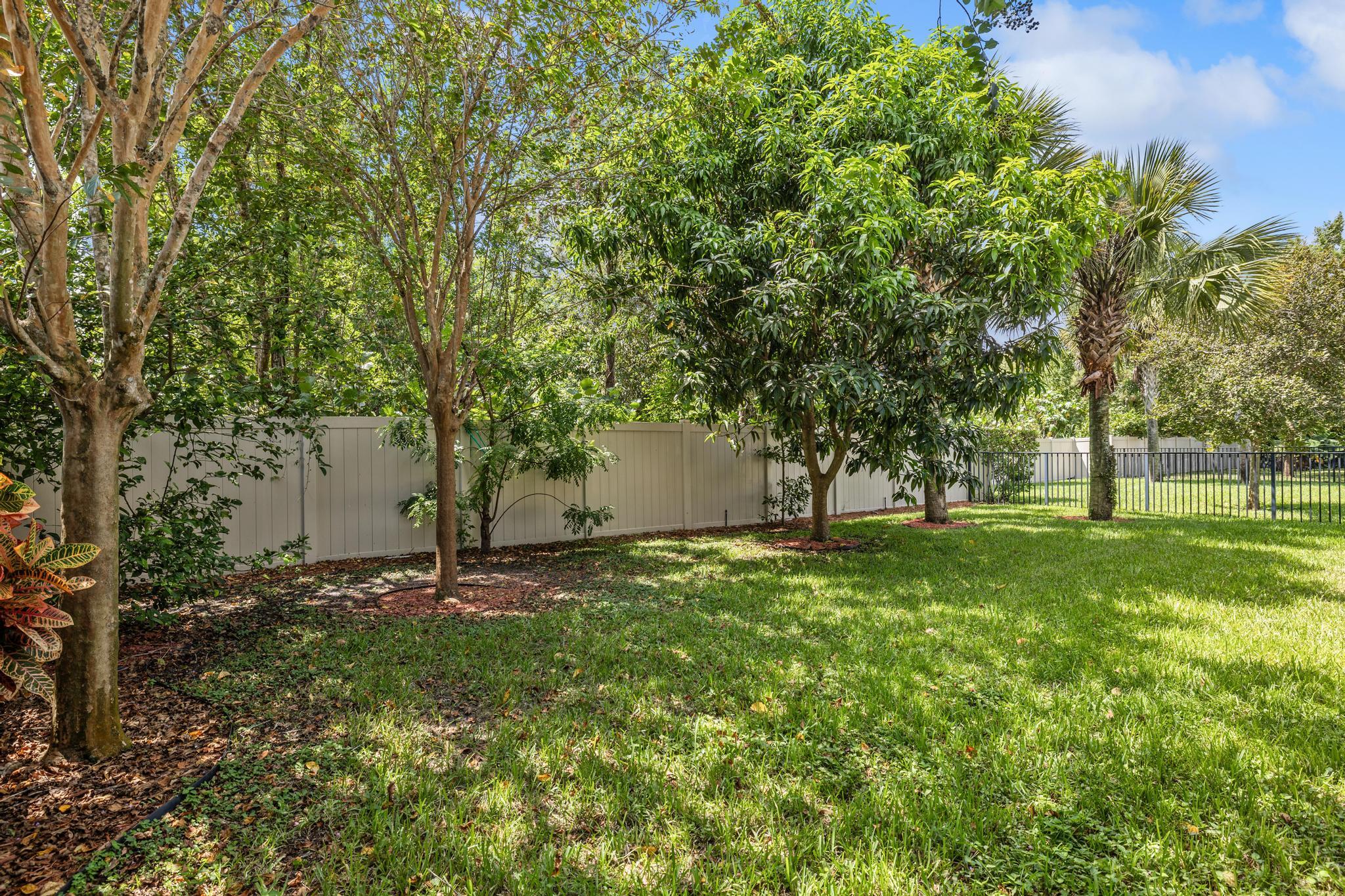 7034 Limestone Cay Road Jupiter, FL 33458 - Photo 31 of 43 a backyard of a house with lots of green space