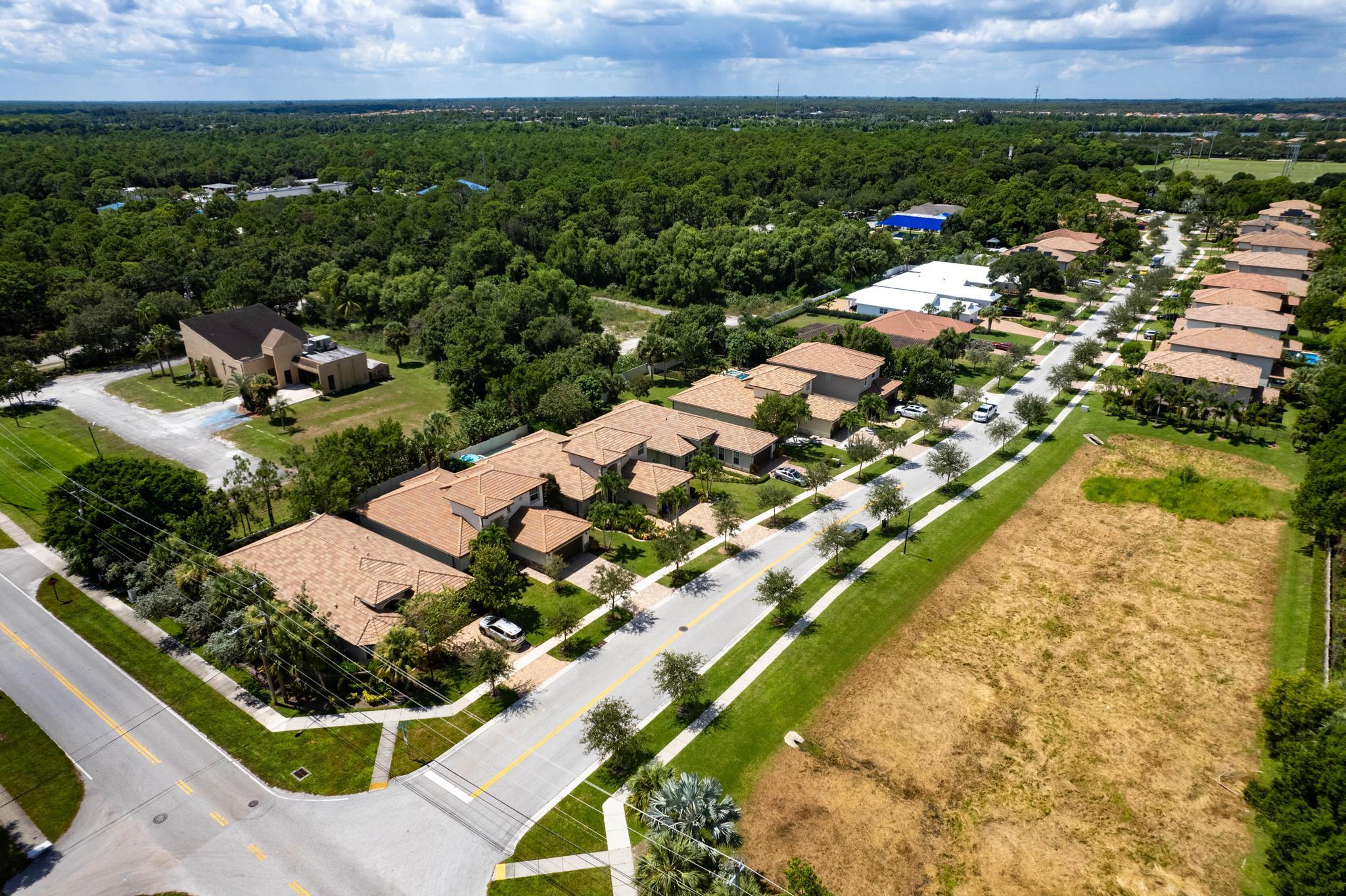 7034 Limestone Cay Road Jupiter, FL 33458 - Photo 36 of 43 an aerial view of a residential houses with outdoor space and street view