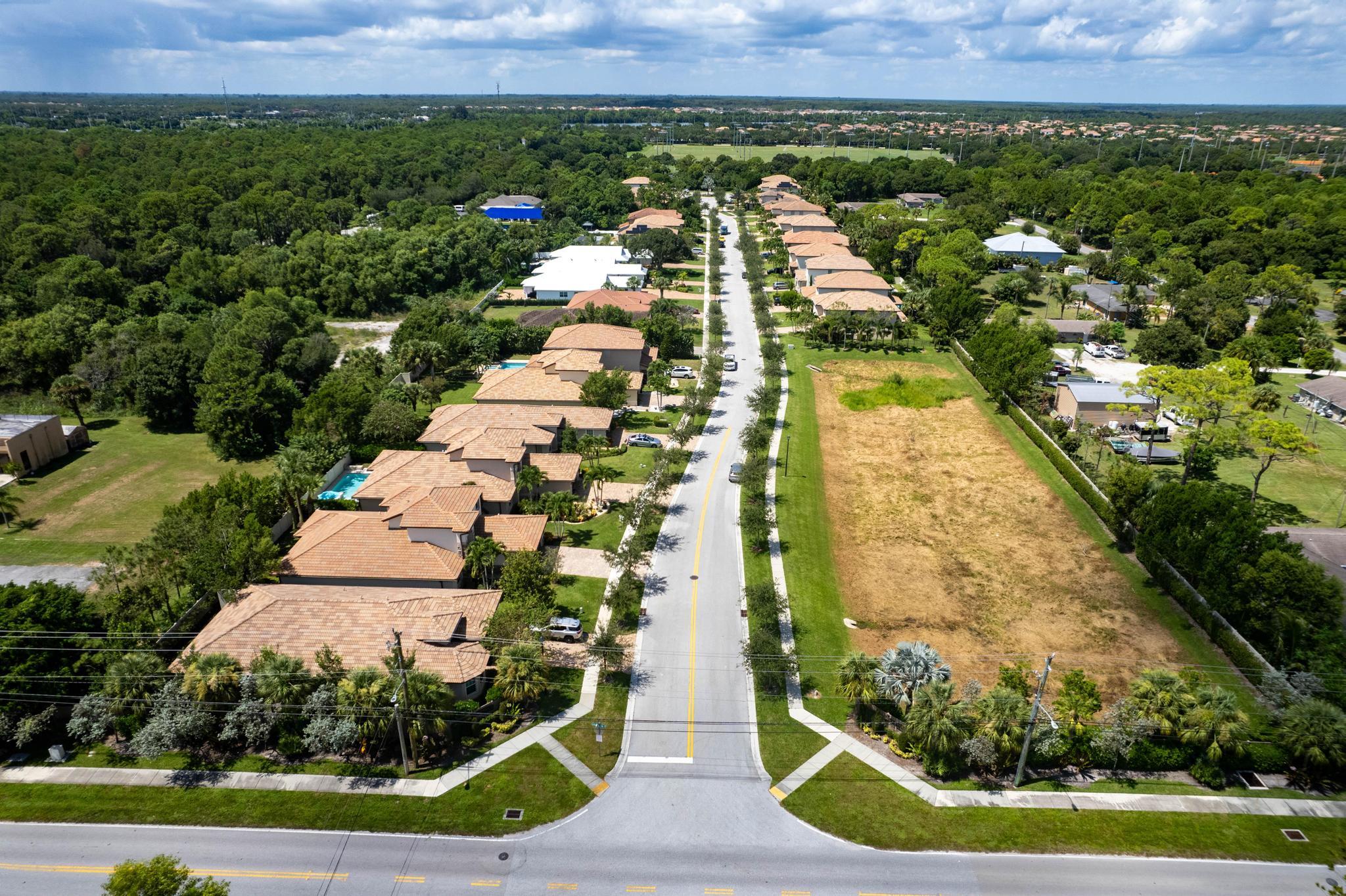 7034 Limestone Cay Road Jupiter, FL 33458 - Photo 37 of 43 an aerial view of residential houses with outdoor space and trees