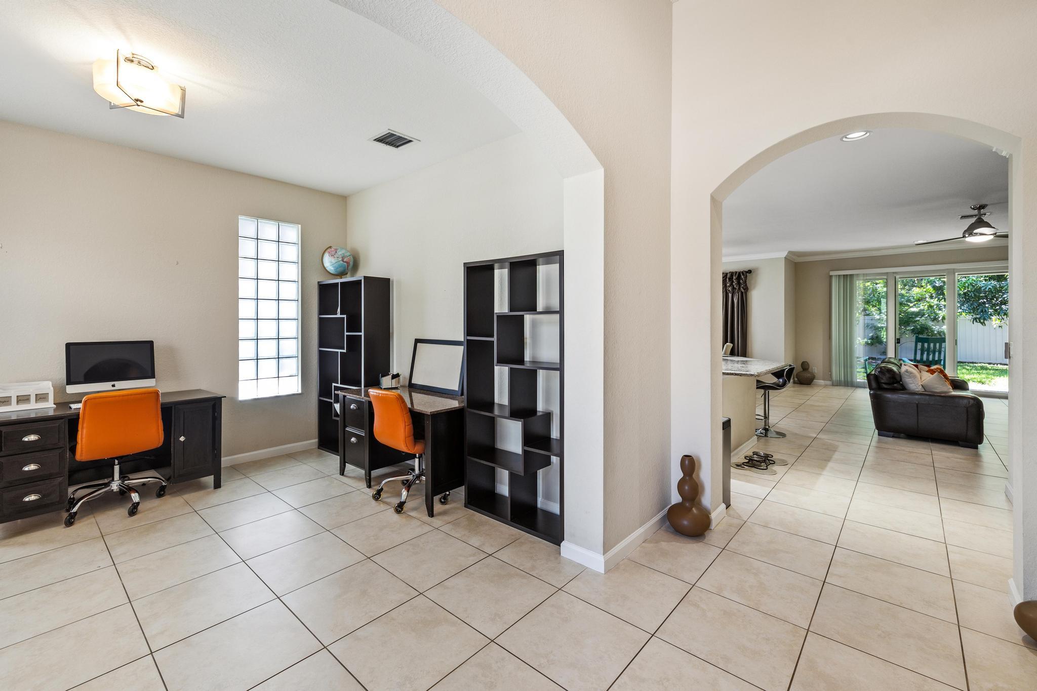 7034 Limestone Cay Road Jupiter, FL 33458 - Photo 7 of 43 a bedroom with furniture and a window