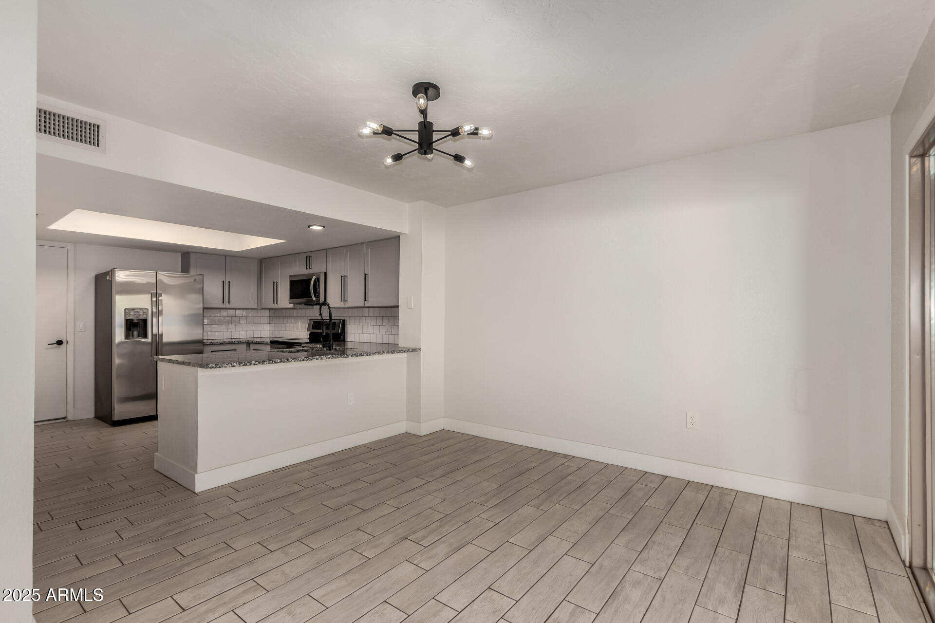 1621 North Chippewa Drive Chandler, AZ 85224 - Photo 10 of 25 a kitchen with a refrigerator and white cabinets