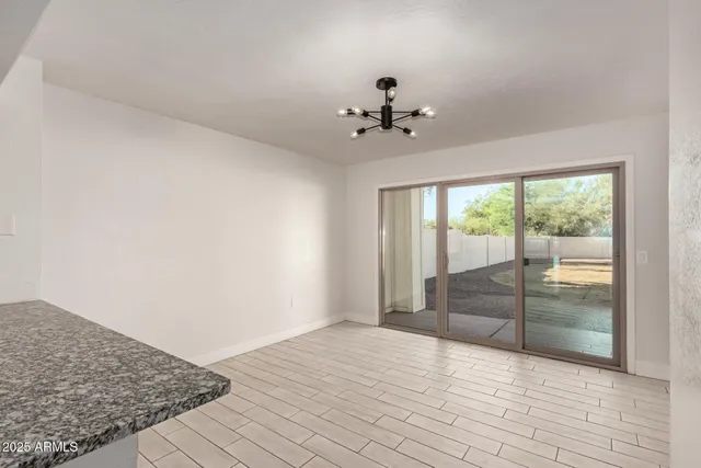a kitchen with a refrigerator and white cabinets