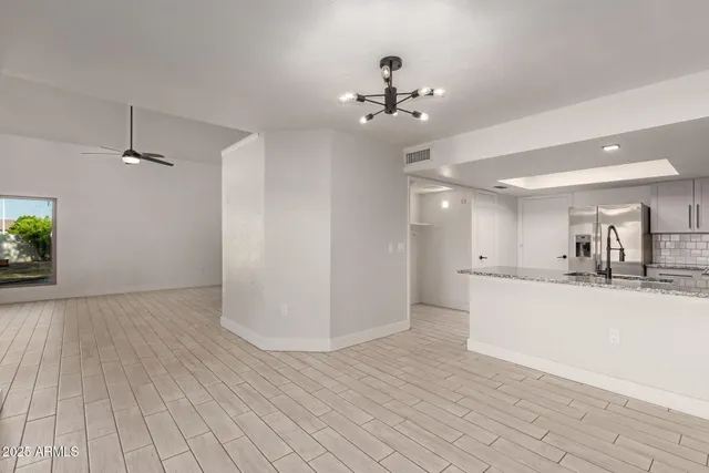 a kitchen with kitchen island granite countertop a stove sink and microwave