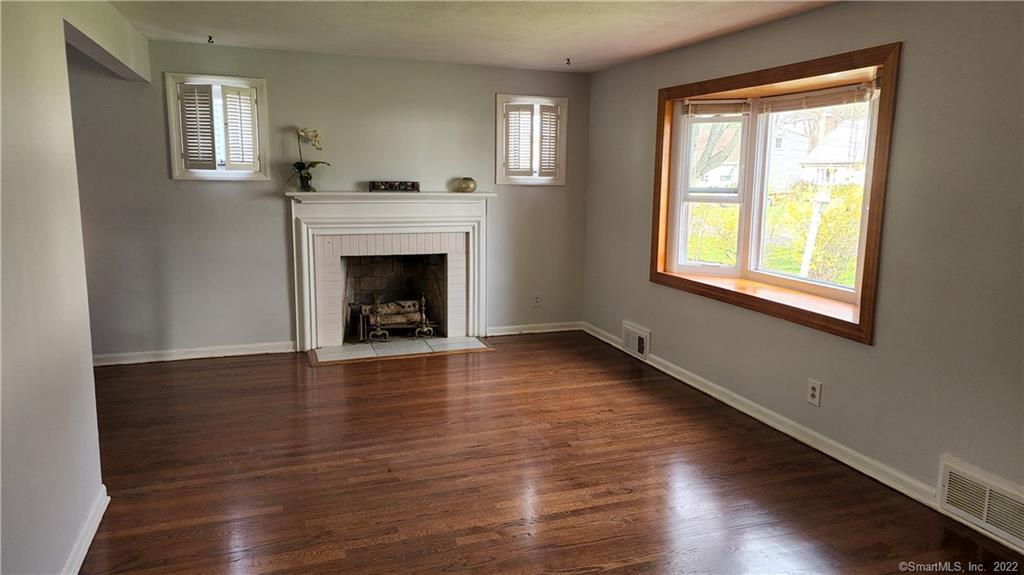 25 Madsen Road West Hartford, CT 06110 - Photo 2 of 16 a view of an empty room with wooden floor and a window