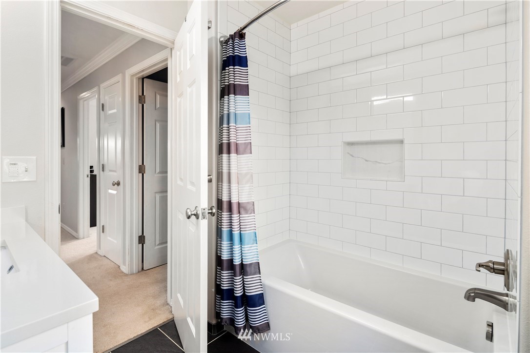 23221 14th Place West Bothell, WA 98021 - Photo 25 of 40 a bathroom with a bathtub and a shower