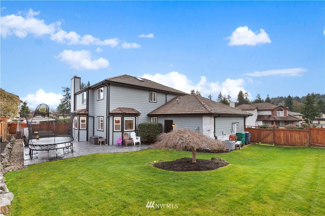 23221 14th Place West Bothell, WA 98021 - Photo 35 of 40 a front view of a house with a garden and plants