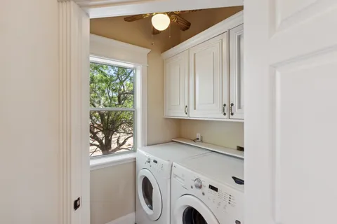 a view of washer and dryer with kitchen in the background