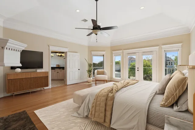 a living room with a bed furniture and a flat screen tv