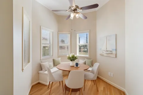 a view of a dining room with furniture window and wooden floor