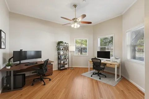 a view of a workspace with furniture and a window