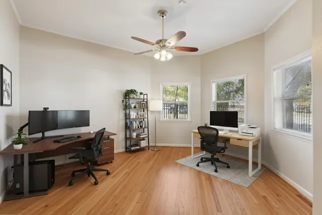 a view of a workspace with furniture and a window