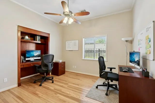 a view of a workspace with furniture and a window
