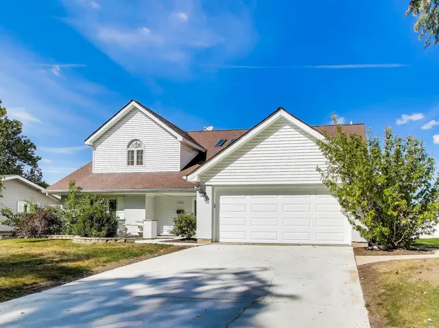 a view of a house with a yard and garage
