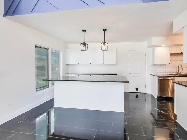 a utility room with cabinets and a fireplace