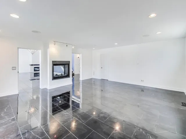 a view of kitchen and living room with a fireplace
