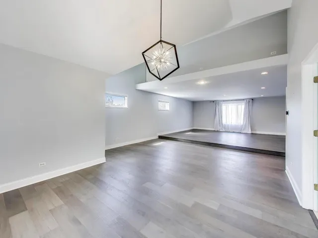 a view of a room with wooden floor and window